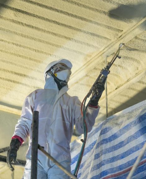 A skilled worker installing fiberglass for Attic Insulation