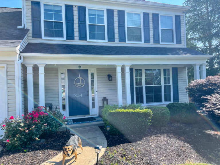 White rain gutter installed on a gray roof of a house
