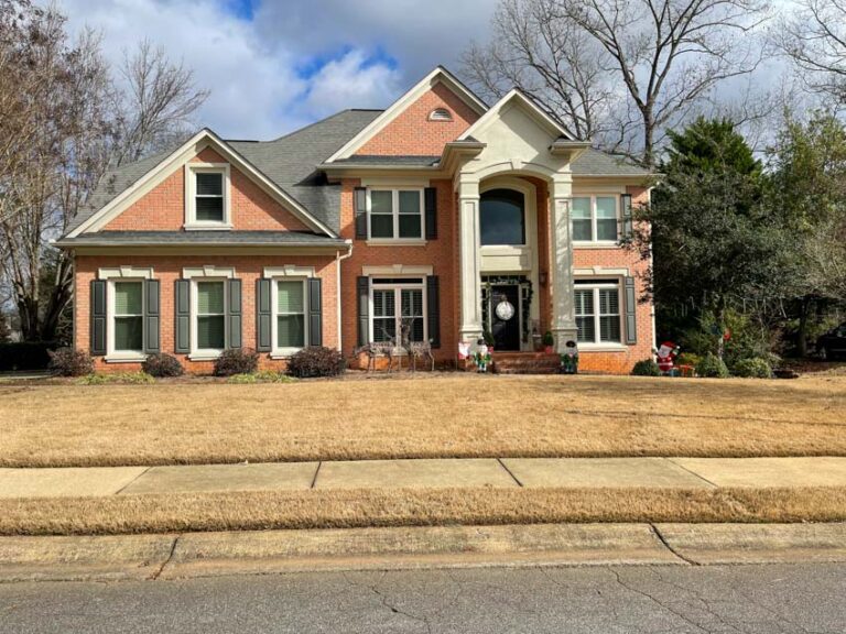 A man installing a gutter for proper drainage in cases of rainfall