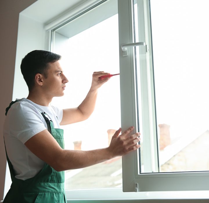 A woman frustrated upon seeing the growth of molds on the wall below the window