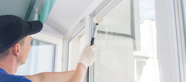 An expert working on a house to replace the window